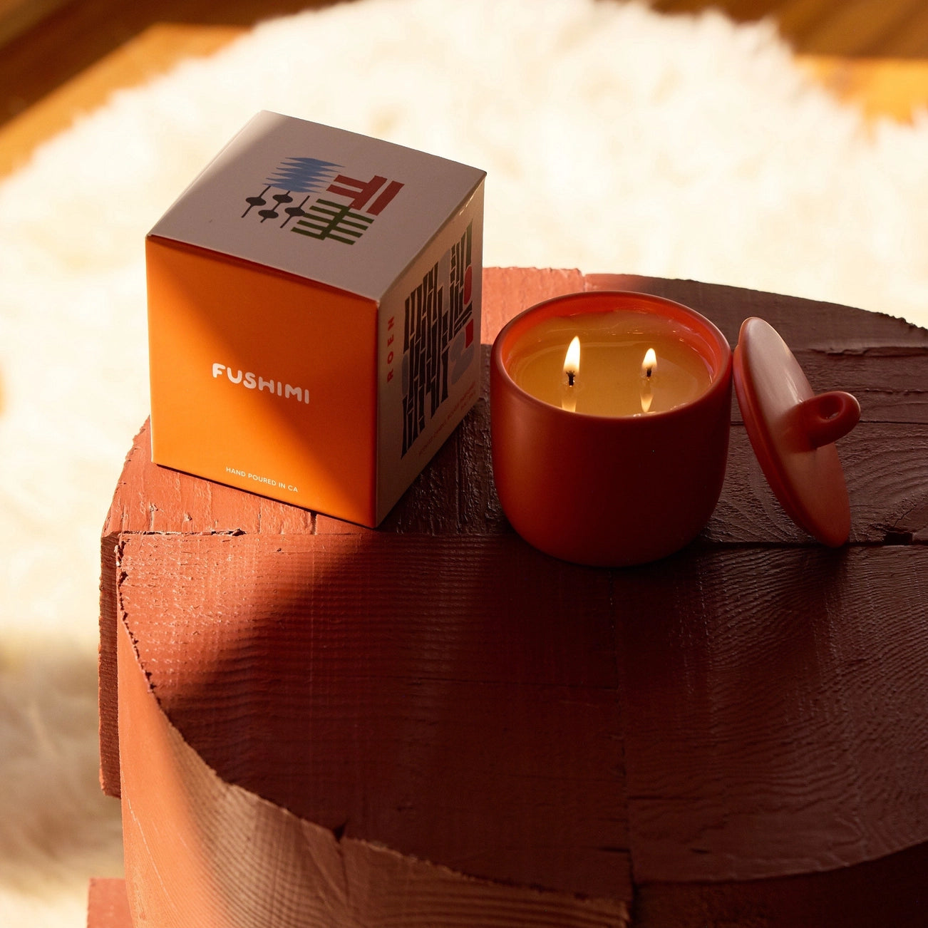 Fushimi candle with packaging on a wooden surface