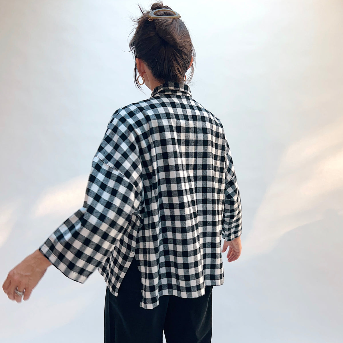 Eleven Stitch Big Check Big Shirt in Black & White, back view showing the oversized silhouette and mustard contrast side vents in large black and white gingham check cotton flannel