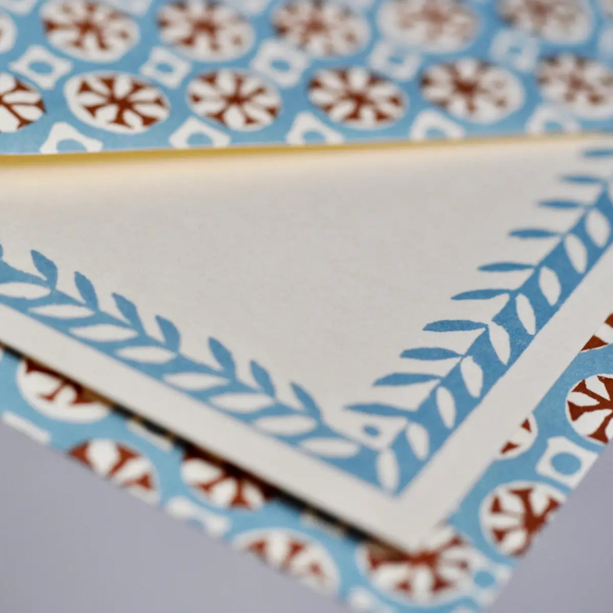 Close-up of decorative tiles with geometric patterns on a blue and white background