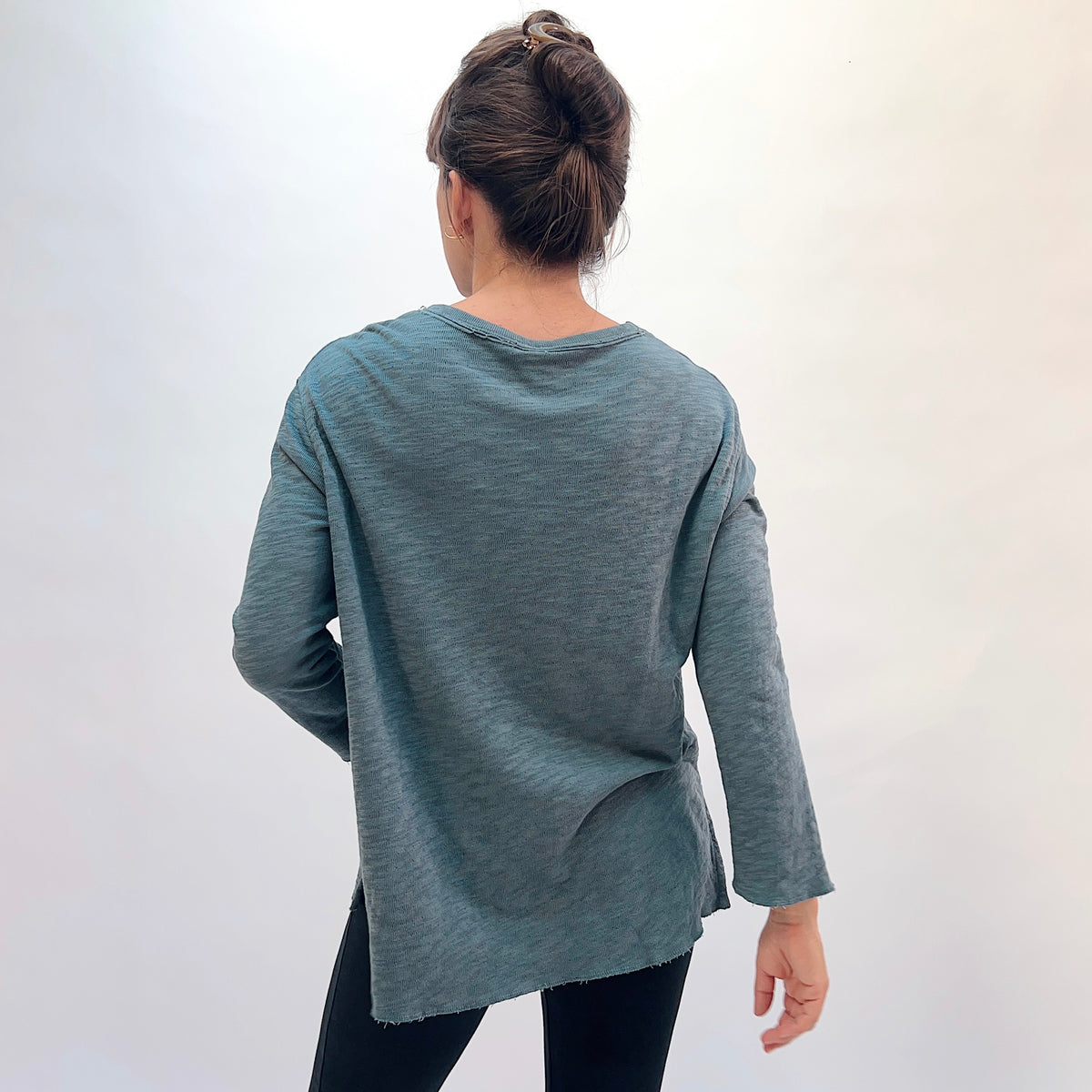 North Star Base Double Cotton Beach Tee in Dusty Denim, back view showing the longer hi-lo hem and side slits in dusty teal double-layered cotton