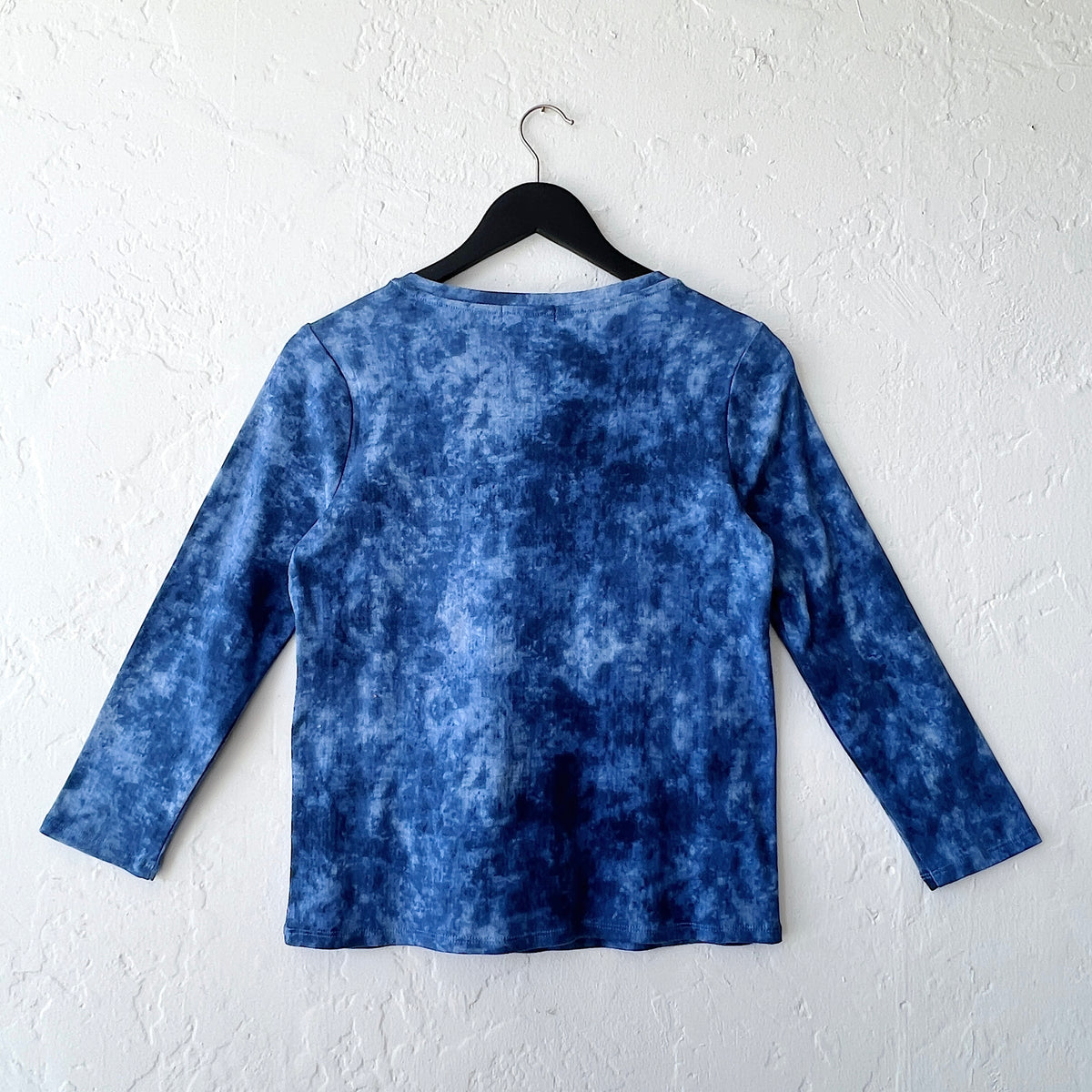Habitat Marble Crewneck in Indigo on hanger, back view showing indigo cloud-dye marble print on 100% cotton knit, crewneck, 3/4 sleeves, and relaxed boxy silhouette with topstitched straight hem