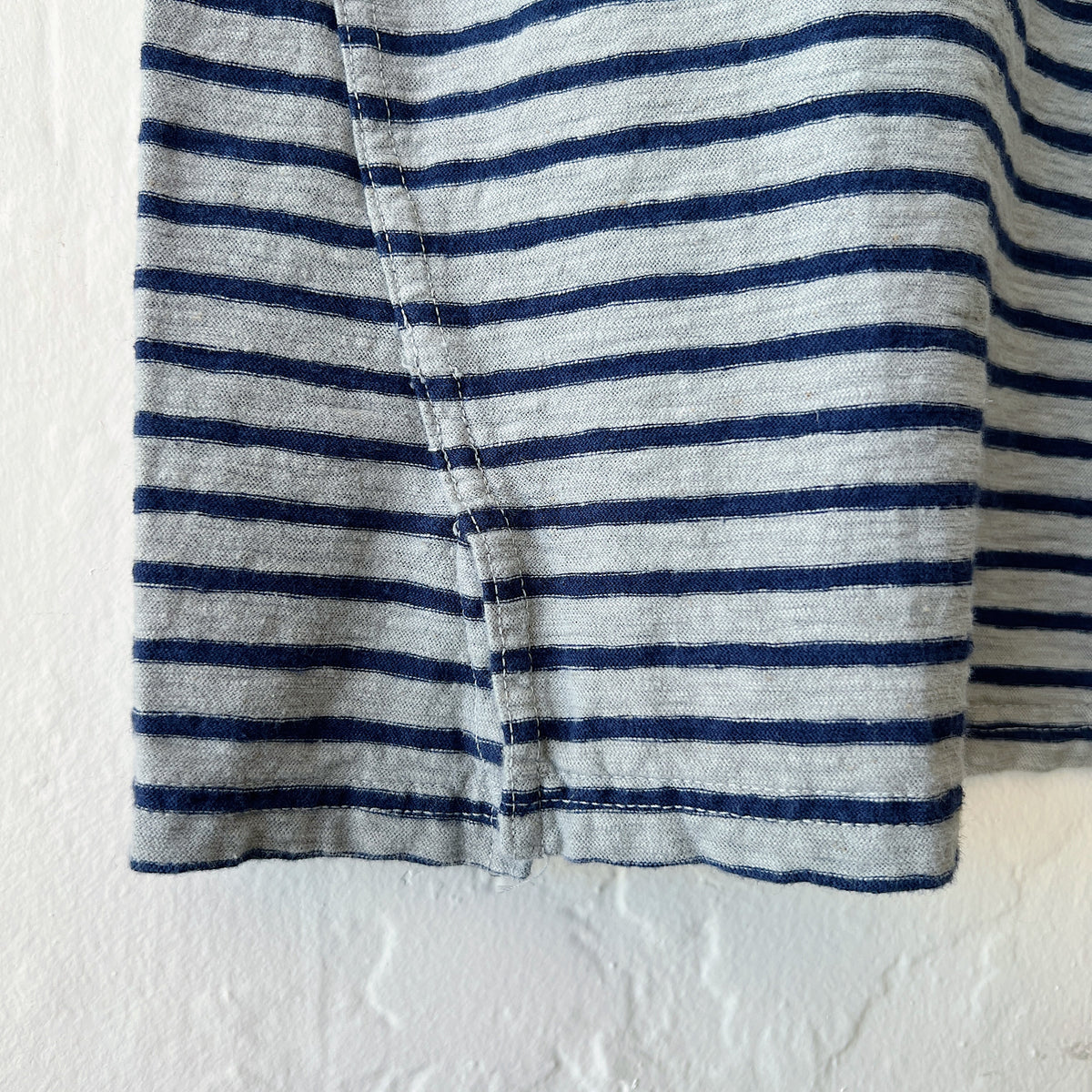 Close-up of fabric with gray and black horizontal stripes on a white background