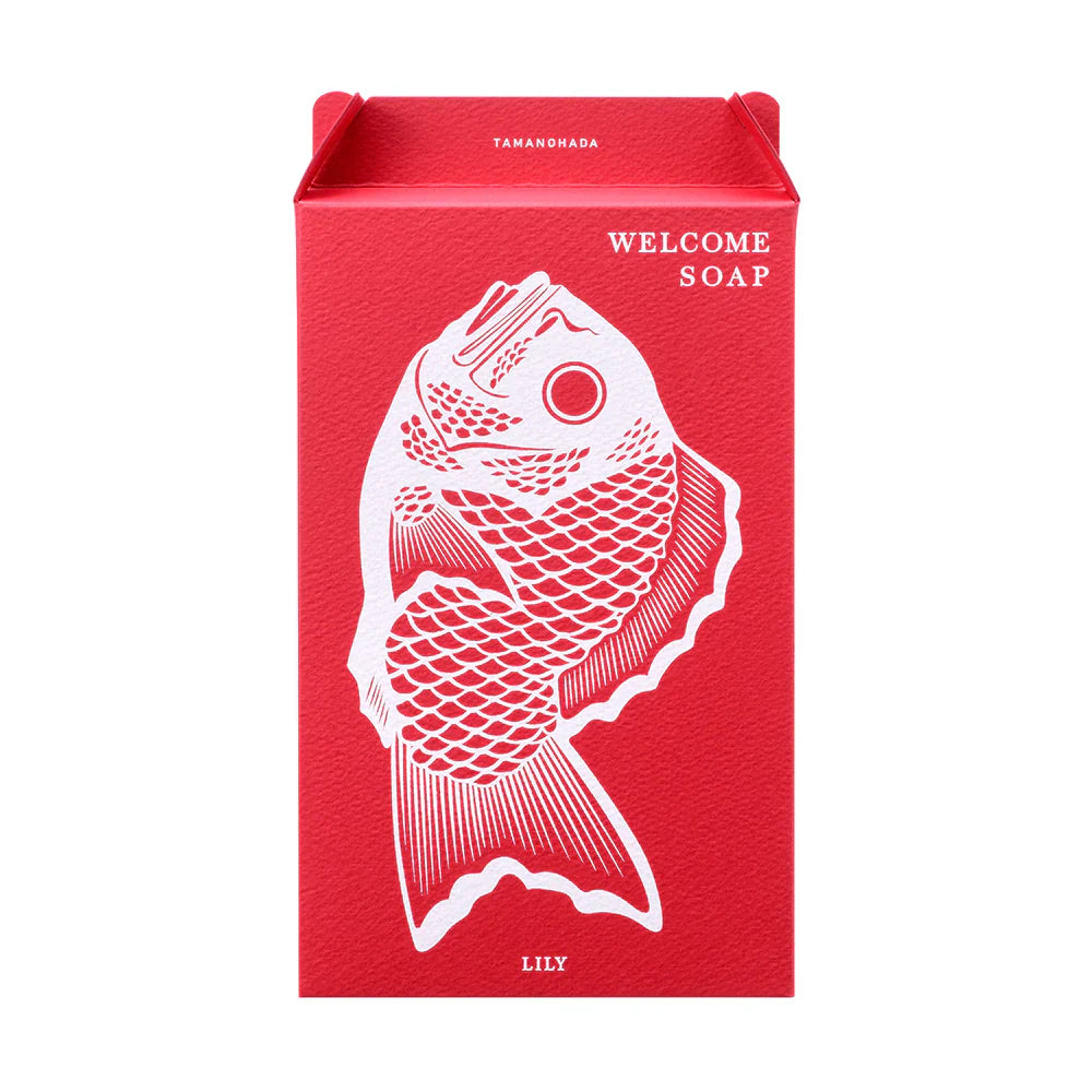 Tamanohada Lily Welcome Soap gift box — red rectangular box with white bream fish illustration and 'Welcome Soap' text, 'Lily' printed at the bottom, Tamanohada branding at the top