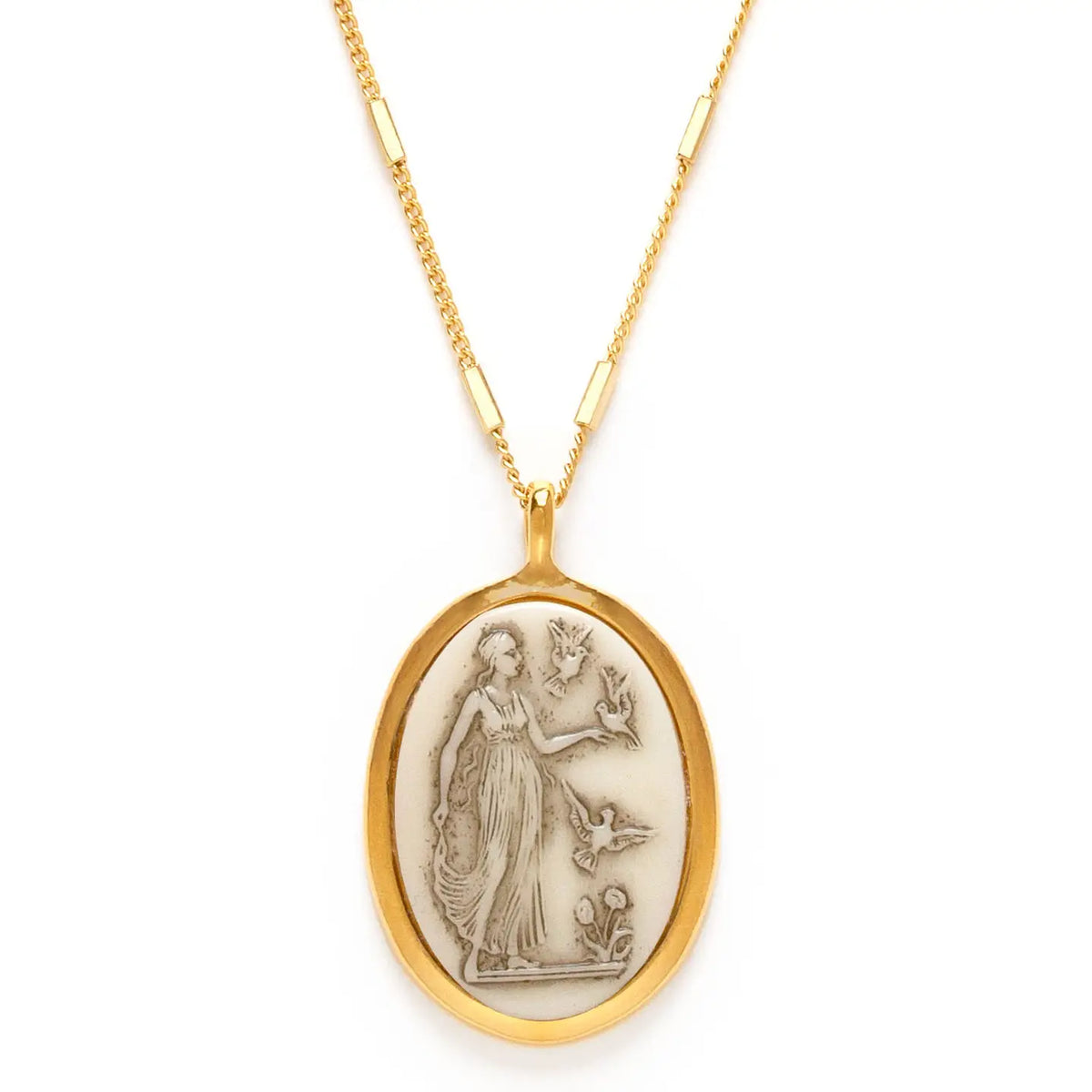 Gold necklace with an oval pendant featuring a classical design on a white background