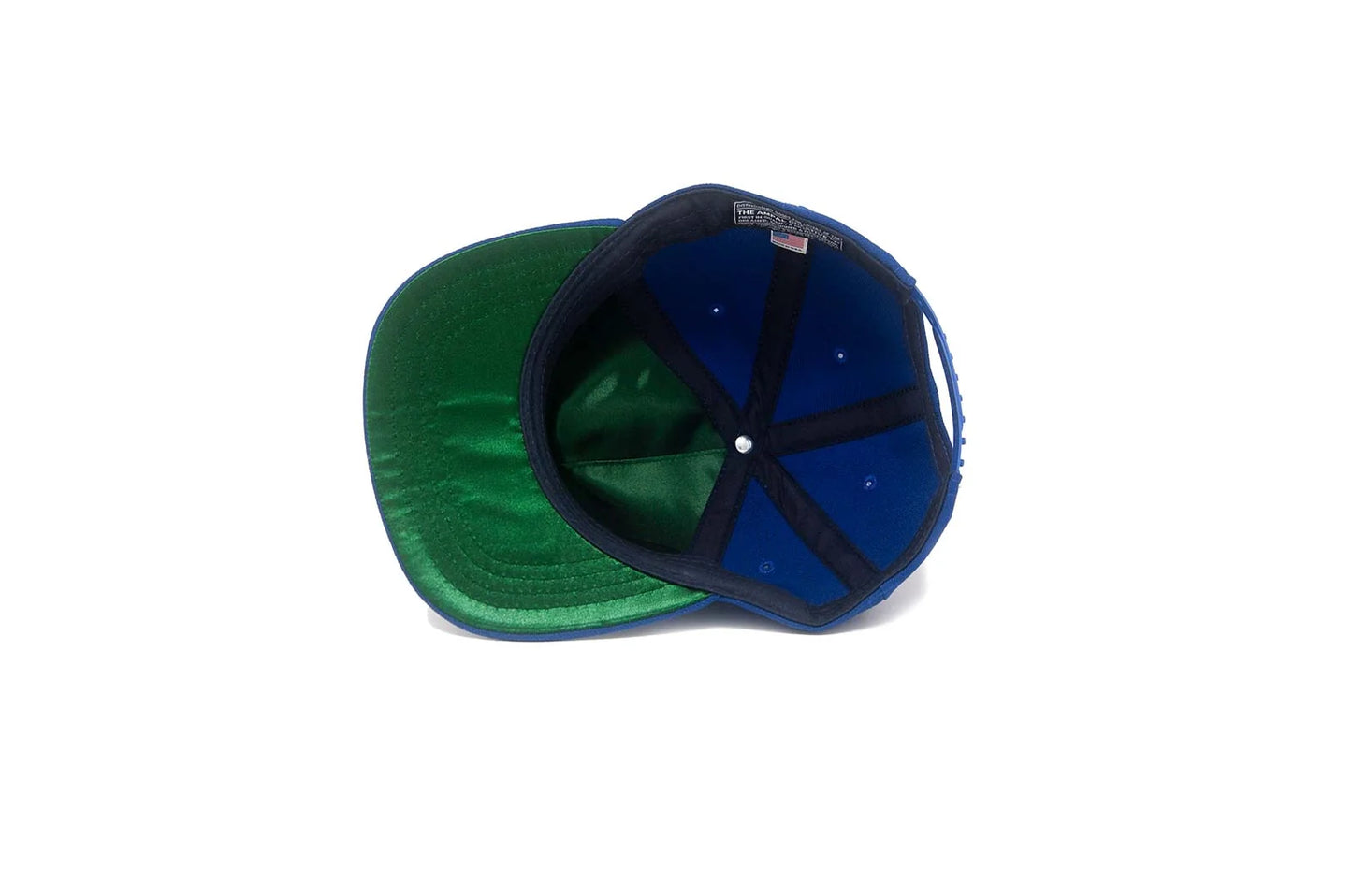 Interior view of the LA City III Series Stadium Snapback in Blue, showing the green satin underbrim and blue crown lining with The Ampal Creative label.