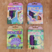 Load image into Gallery viewer, four boxes of rainbow colored pencils sit in a grid on a hardwood floor. each package has a different dinosaur illustration on the front. from left top right, top to bottom, there is a brontosaurus, a pterodactyl, a stegosaurus, and a t-rex.
