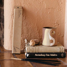 Load image into Gallery viewer, Pinon incense resting next to a stack of books and ceramic mug.