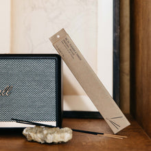 Load image into Gallery viewer, The teakwood and tobacco package leaning against a piece of stereo equipment.