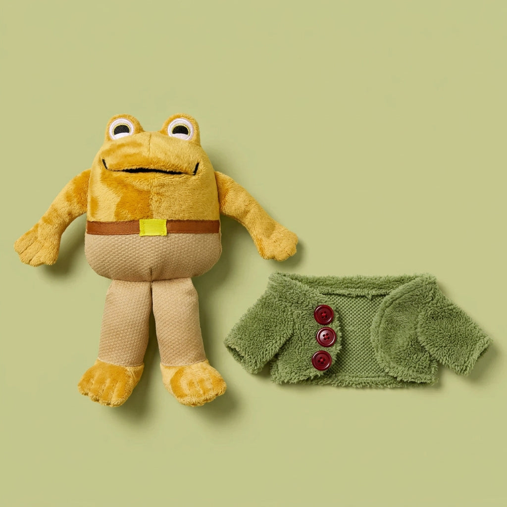 Toad plush toy in tan pants and a ribbon belt, with its green jacket removed and laid beside it.