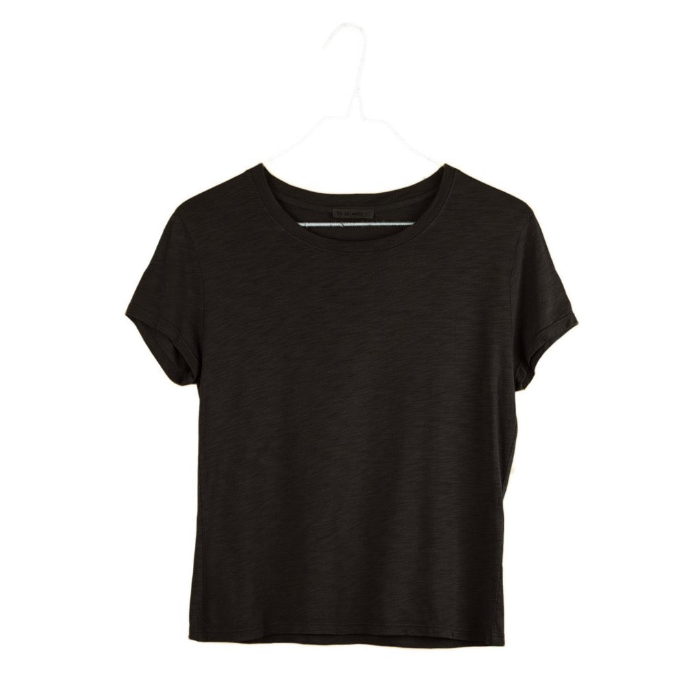 It Is Well Cropped Tee in Black, flat hanger shot on white background showing solid black lightweight slub jersey, clean crew neck, short fitted sleeves with slight cuff, and slightly cropped length in a slim petite fit