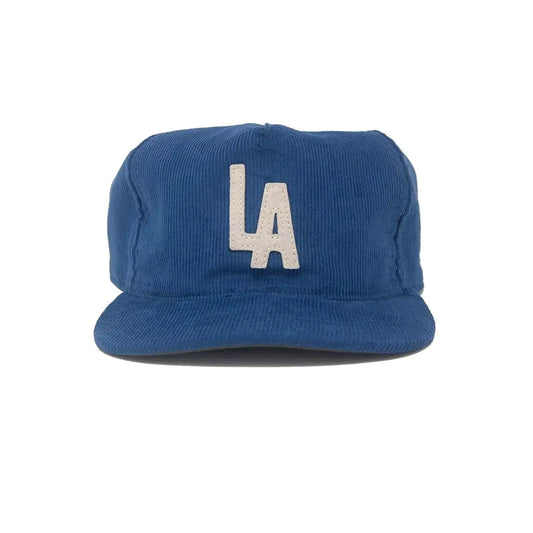 Blue cap with 'LA' logo on a white background