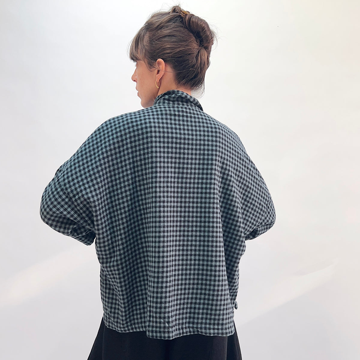 Eleven Stitch Small Check Big Shirt in Dusty Denim, back view showing the relaxed boxy silhouette and mustard contrast side vents in dusty teal and black small gingham check flannel
