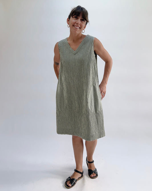 Cut Loose V-Neck Shift Dress in Balsam Green Stripe, front view on model, sleeveless with v-neckline, two front patch pockets, knee-length, worn with black sandals
