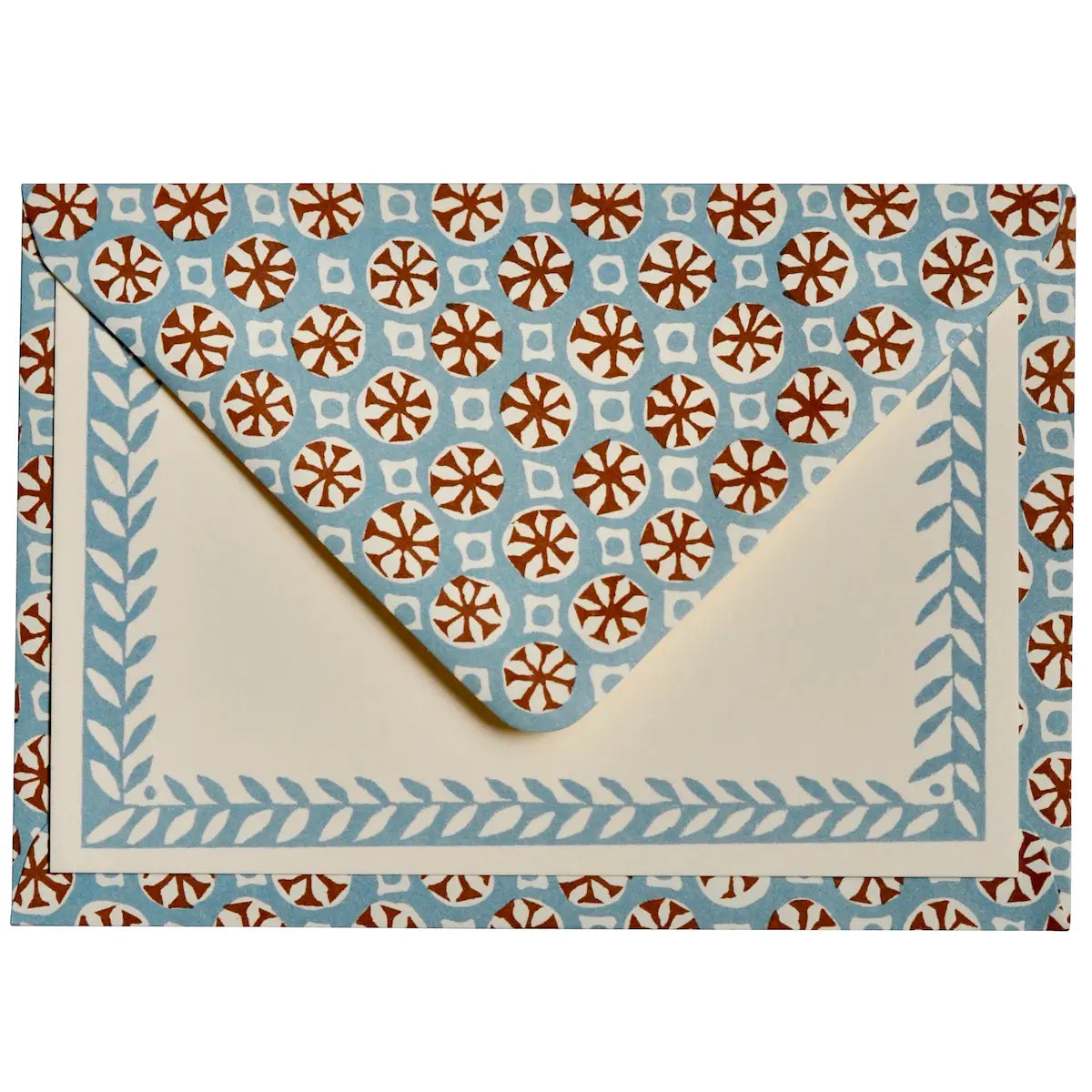 A square envelope with a cream-colored interior and a light blue border decorated with a leaf pattern, set against a matching patterned background. The patterned background features repeating brown and white floral medallions on a light blue base.