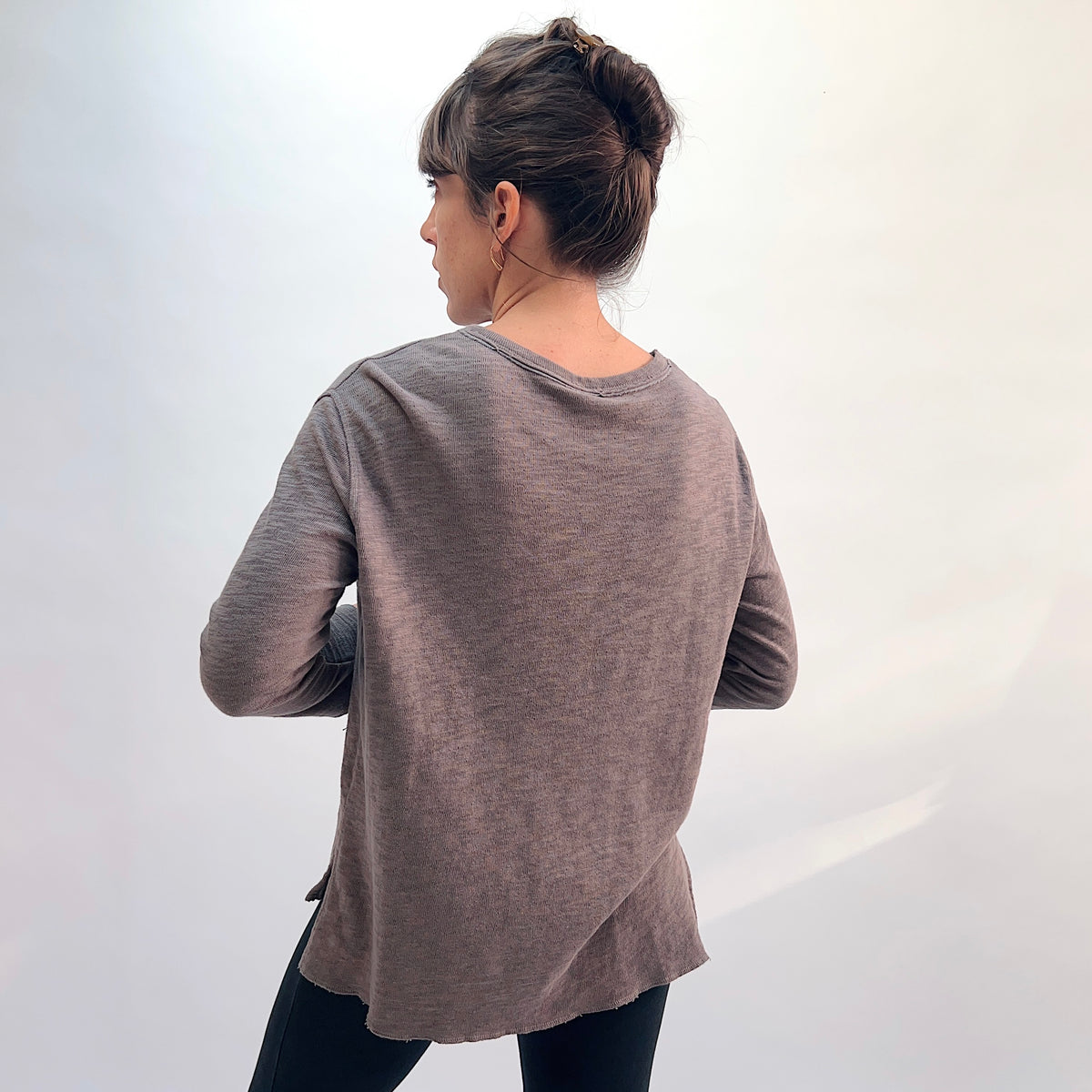 North Star Base Double Cotton Beach Tee in Eiffel Tower, back view showing the relaxed A-line silhouette, raw-edge hem, and side slits in warm taupe double-layered cotton
