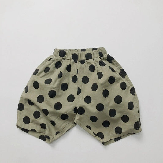 Dotter Linen Blend Pants in Green Polka Dot, flat lay on white background showing sage green 55% linen 45% cotton with bold allover black polka dot print, high elasticated waistband with gathered fullness, side pockets, and voluminous ballooned cropped leg
