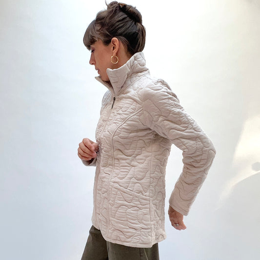 Habitat Cascade Quilted Coat in Dove, side view showing the stand collar, zip-front, and organic abstract quilting pattern
