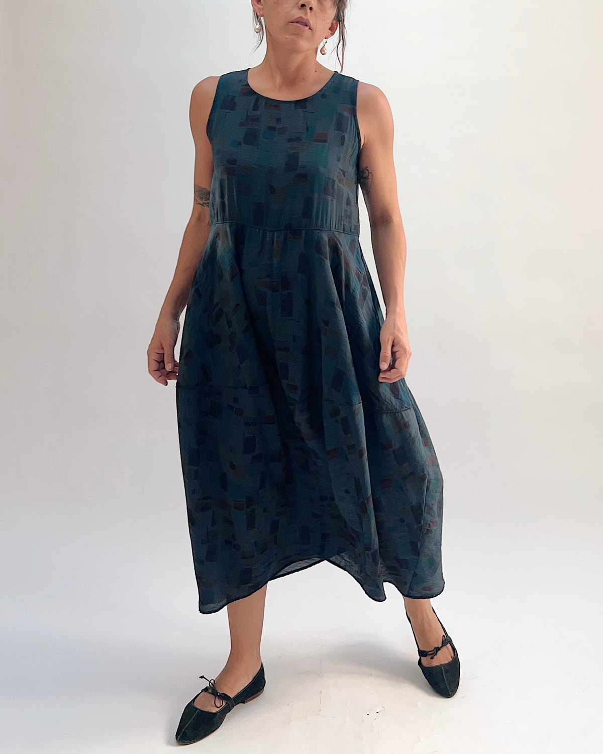 Front view of the Cut Loose Sea Glass Seamed Parachute Bubble Dress in Etan in deep teal semi-sheer viscose-nylon with abstract block print, showing the full bubble skirt silhouette and midi length
