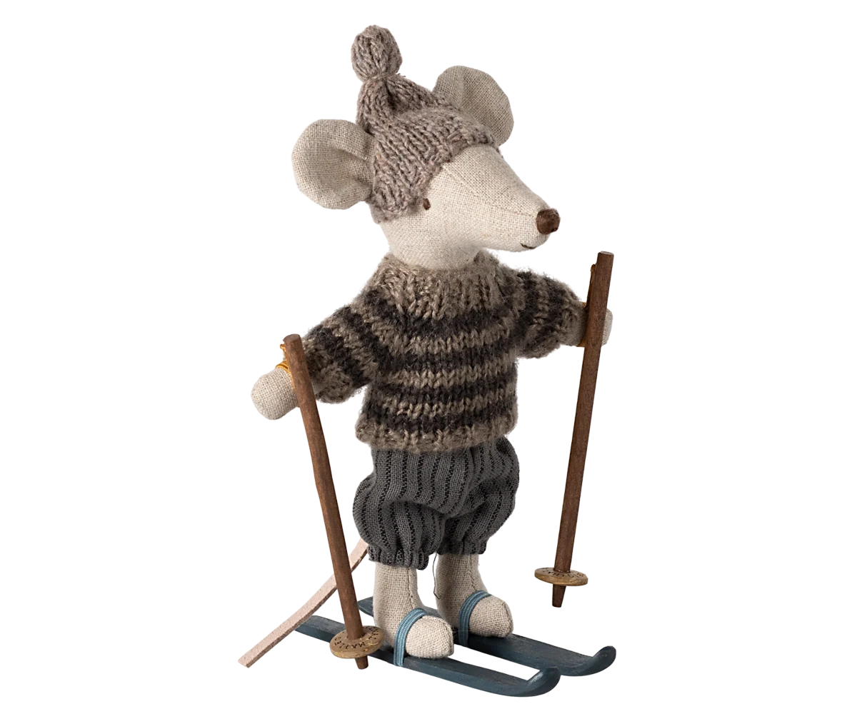 Maileg Winter Mouse Ski Big Brother — full front view of linen mouse doll wearing a taupe knit pompom hat, brown striped knit sweater, dark ribbed knickerbockers, and blue wooden skis with poles
