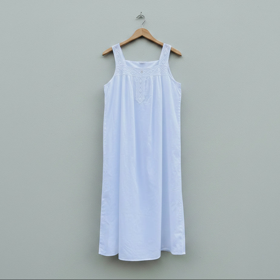 White dress on a hanger against a gray wall