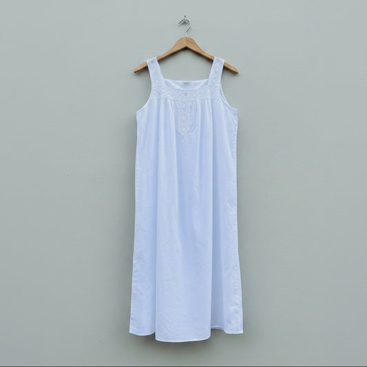 White dress on a hanger against a gray wall