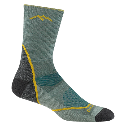 Green hiking sock with yellow accents on a white background