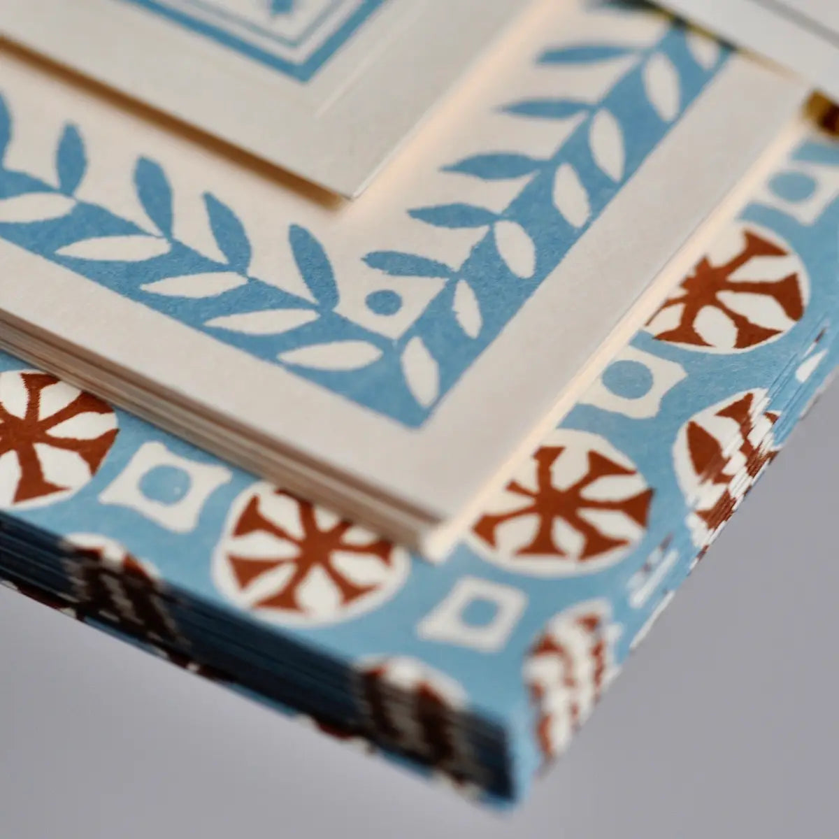 Close-up of a deck of cards with decorative patterns on a gray background