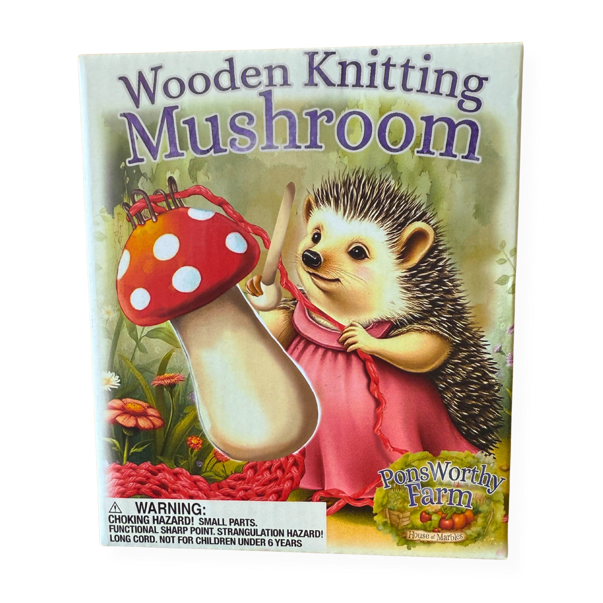 Wooden Knitting Mushroom box front with a hedgehog illustration and red-and-white mushroom knitting tool.
