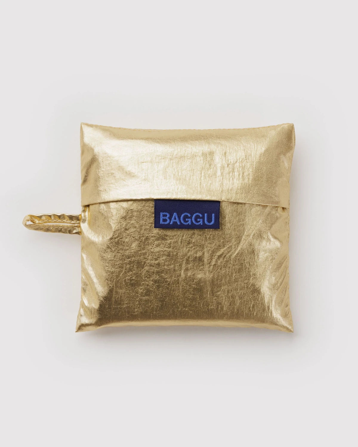 BAGGU Baby Baggu in Metallic Gold, shiny gold storage pouch with a visible BAGGU label.
