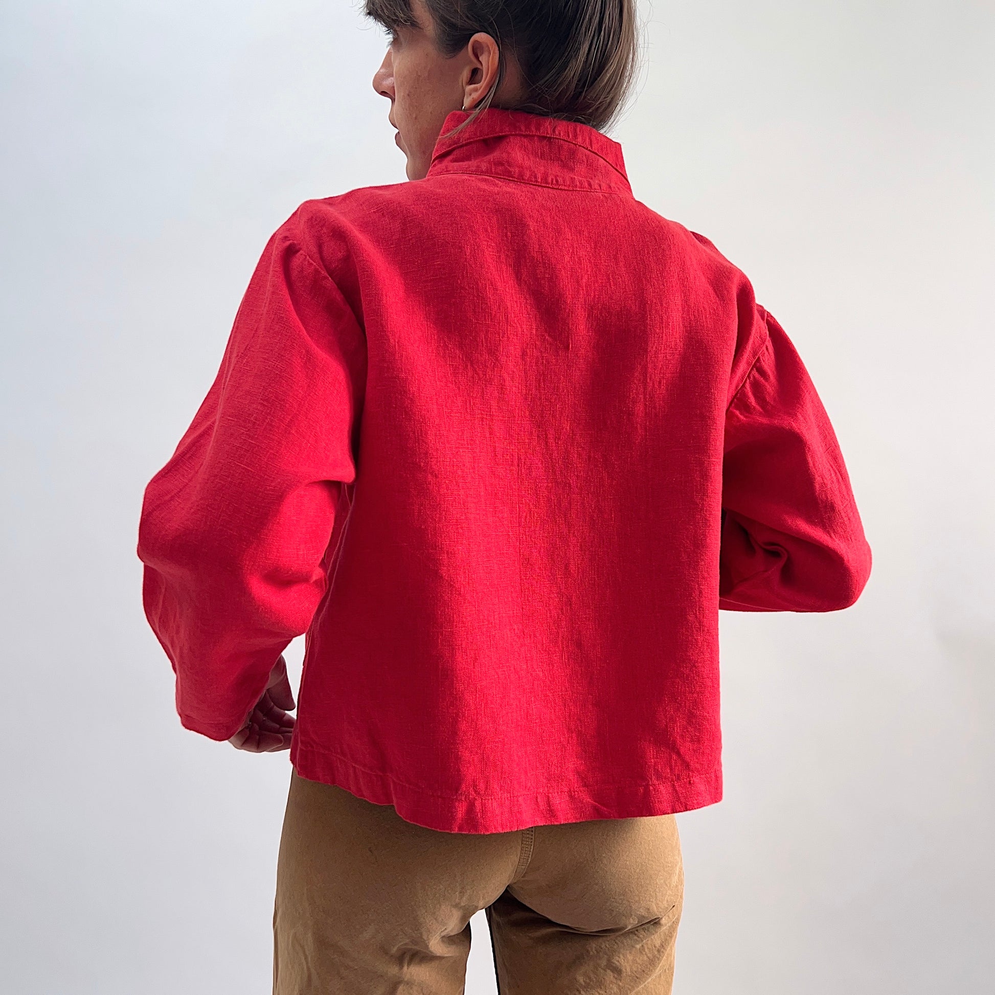 Back view of the Bryn Walker Heavy Linen Audrey Jacket in Hawthorn, showing cropped hemline, linen texture, and relaxed silhouette
