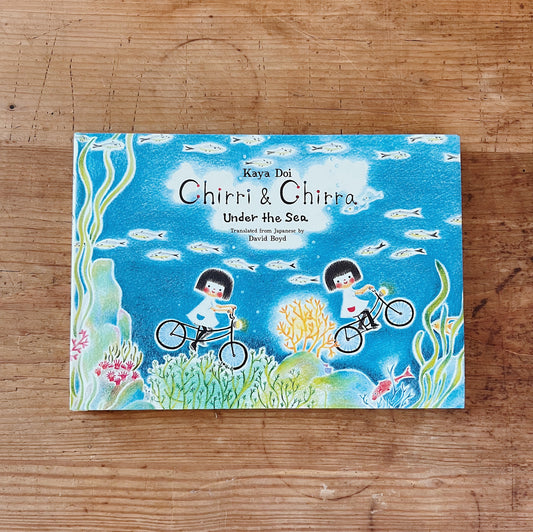Hardcover book cover of 'Chirri & Chira: Under the Sea' featuring illustration of two characters on bicycles in an underwater scene with coral and fish.