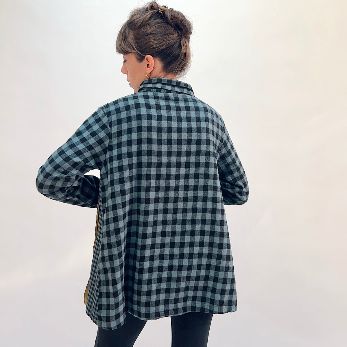 Eleven Stitch Placket Gusset Shirt in Dusty Denim, back view showing the relaxed oversized fit and mustard contrast side gusset vents in dusty blue and black gingham check cotton

