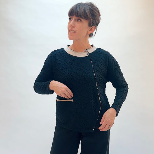 Habitat Crinkled Double Face Metro Pullover in Black, front three-quarter view showing the crinkled texture and contrast crew collar with lettuce edge trim
