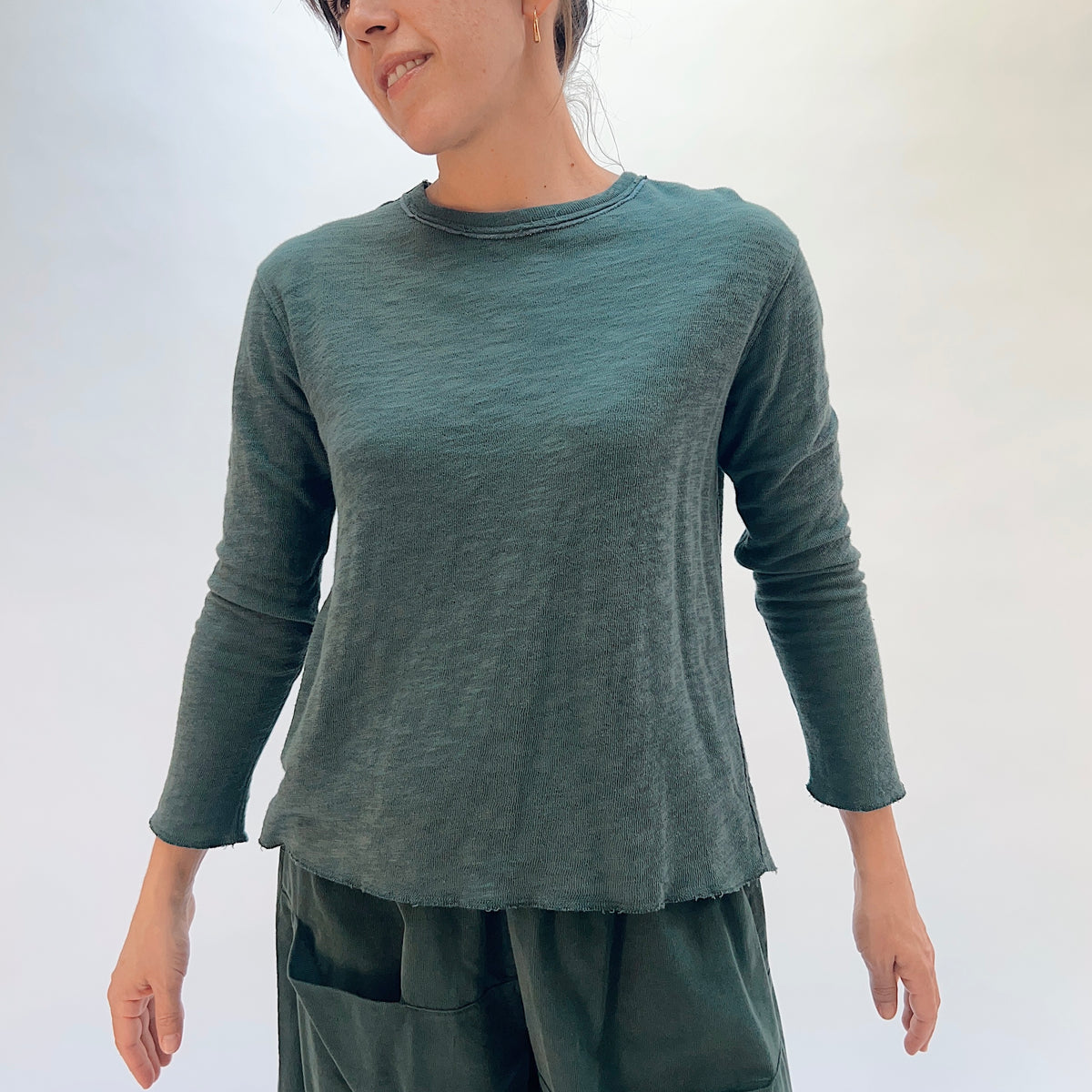 North Star Base Double Cotton Tee in Konbu, front view showing the raw-edge neckline and relaxed fit in konbu green
