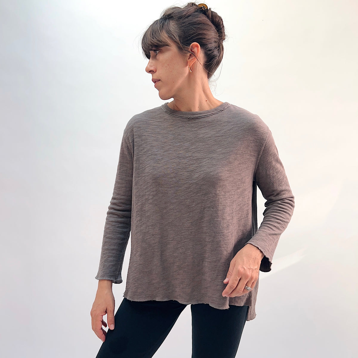 North Star Base Double Cotton Beach Tee in Eiffel Tower, front view showing the relaxed A-line long-sleeve silhouette in warm taupe with exposed raw-edge crew neckline and side slits

