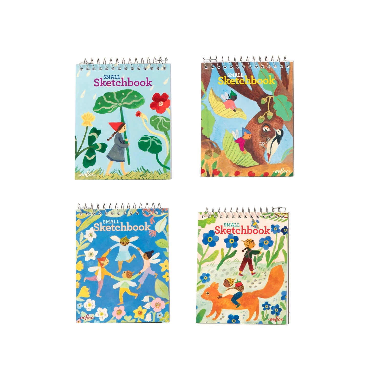 Four Eeboo Cottage Fairies small spiral-bound sketchbooks showing four illustrated covers: a fairy with a leaf parasol among nasturtiums, fairies riding leaves near a woodpecker, fairies dancing in a flower ring, and a child riding a squirrel among forget-me-nots