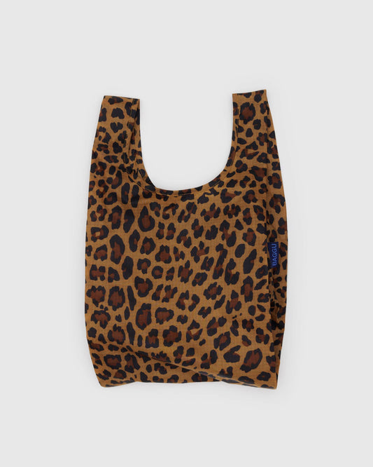 BAGGU Baby Baggu in Leopard, shown unfolded with two handles and brown and black leopard spots on tan fabric.

