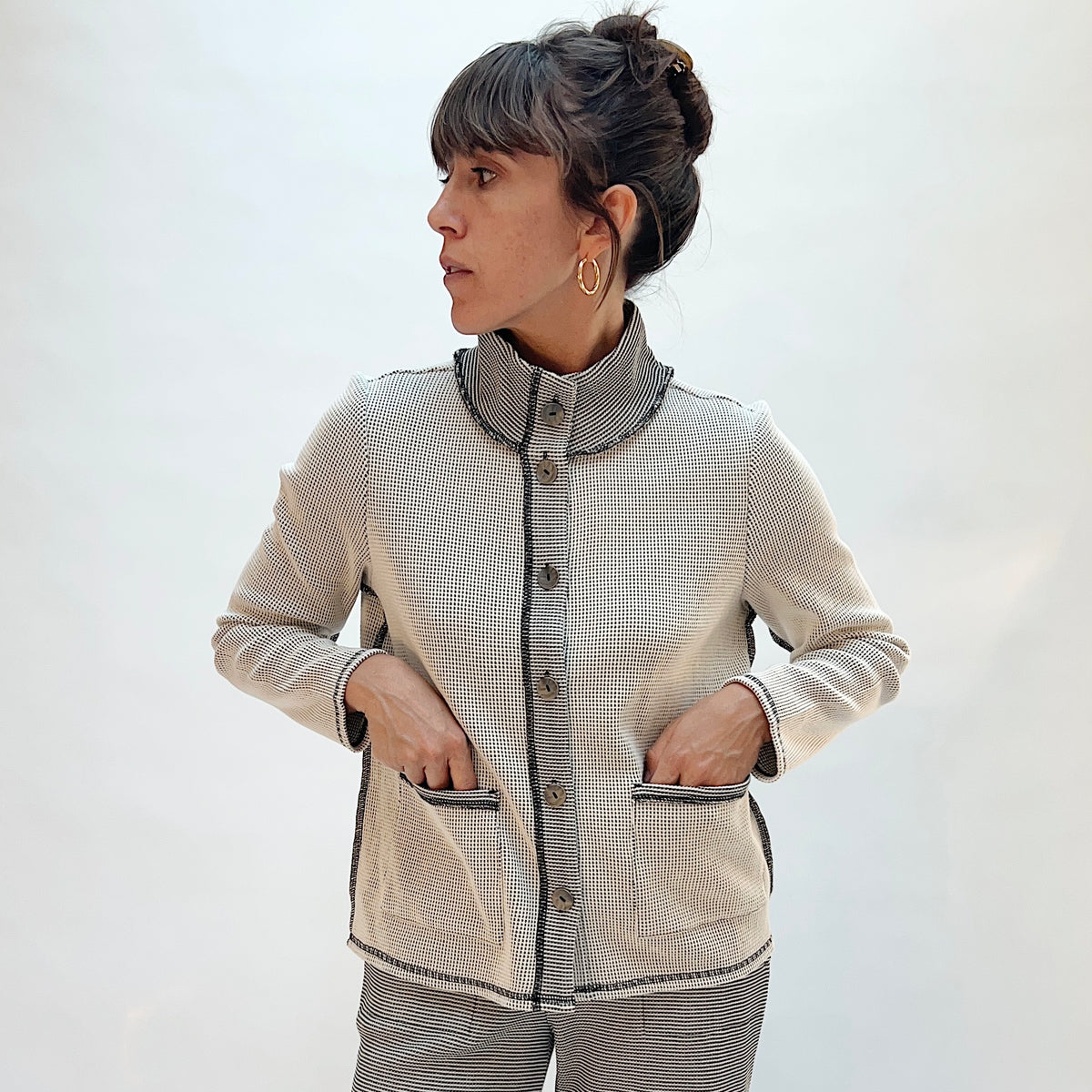 Habitat Opposites Attract Jacket in Winter White, front view showing the button-front closure, stand collar, and two front patch pockets in grid-textured thermal knit
