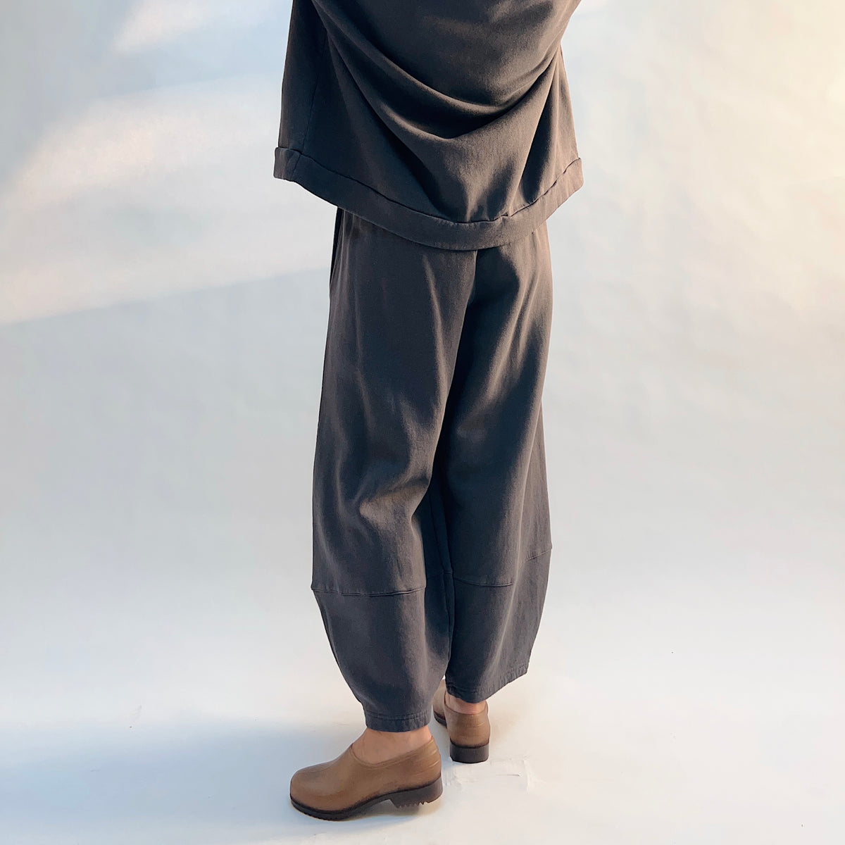 Angled back view of Oliver Fleece Pant in Moonlight, showing the rounded leg shape and horizontal lower-leg seams.
