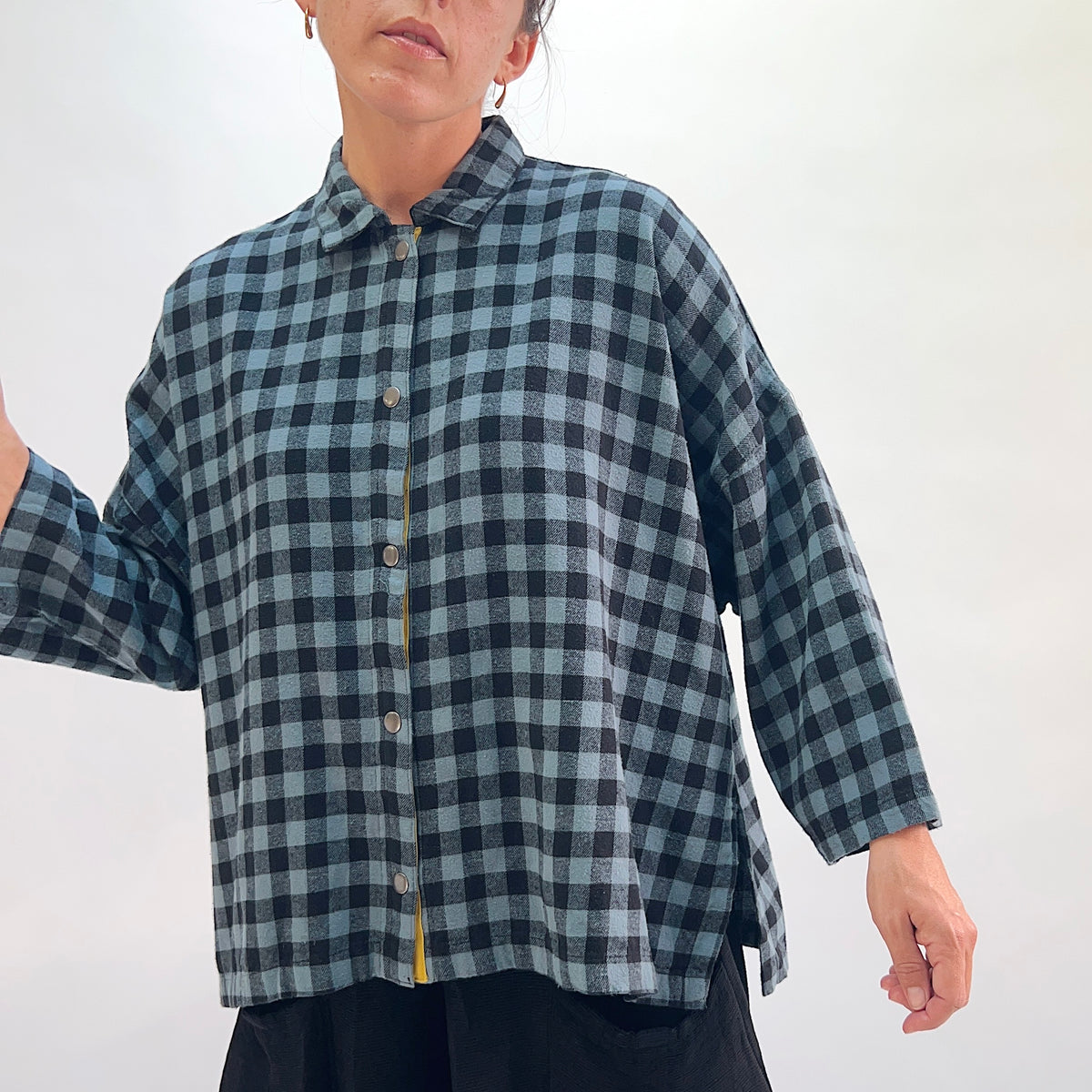 Eleven Stitch Big Check Big Shirt in Dusty Denim, close front view showing the button-front placket with mustard contrast detail in dusty blue and black gingham check cotton flannel
