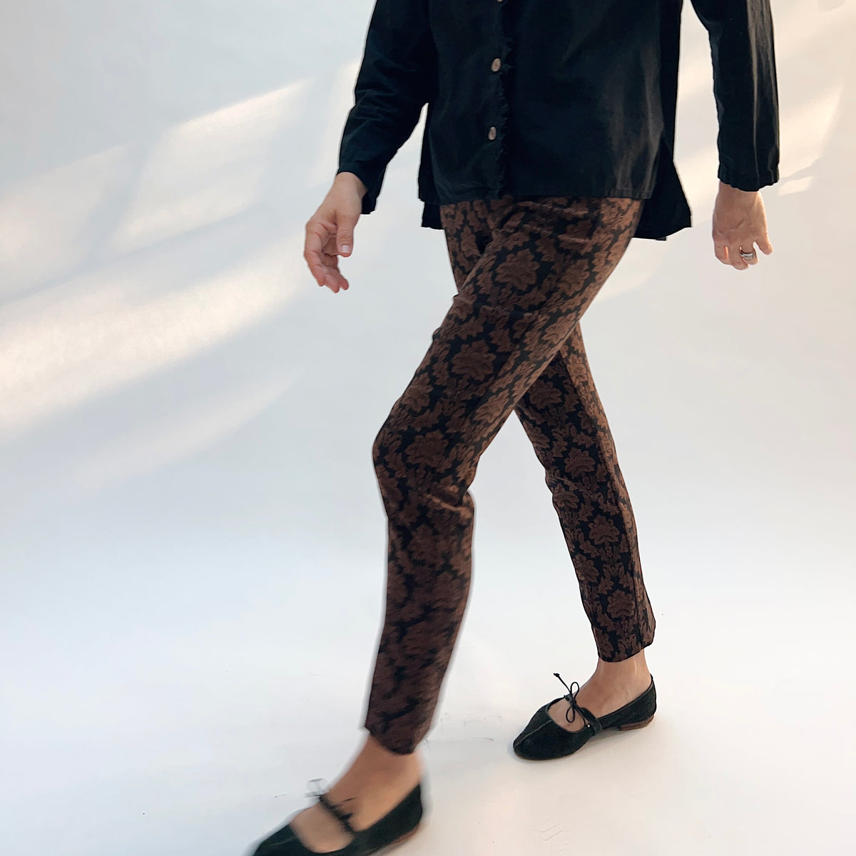 Lisette Chocolate Brocade Cigarette Pant, side view in motion showing the slim silhouette and ankle length in chocolate damask jacquard
