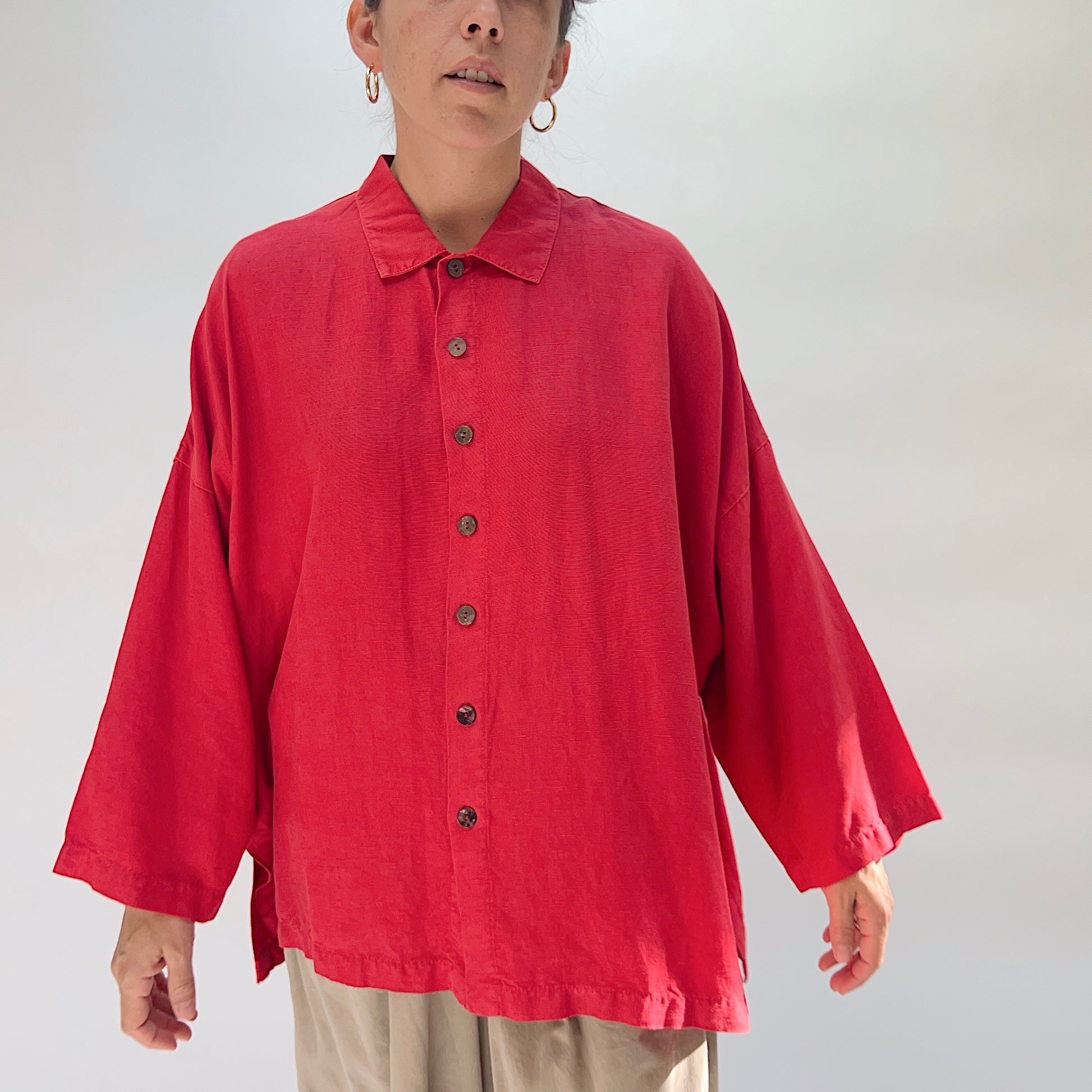Eleven Stitch Linen Blend Big Shirt in Cayenne, full front view on model, showing point collar, six wood button closure, wide dropped shoulders, and relaxed boxy silhouette, paired with khaki wide-leg trousers
