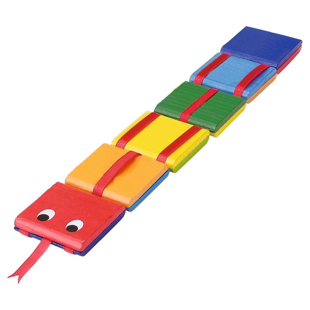 Goki Wooden Cascade Snake laid flat on a white background, showing 6 rainbow-colored wooden segments connected by red ribbon in red, orange, yellow, green, light blue, and dark blue, with a red snake head featuring two googly eyes and a forked red tongue