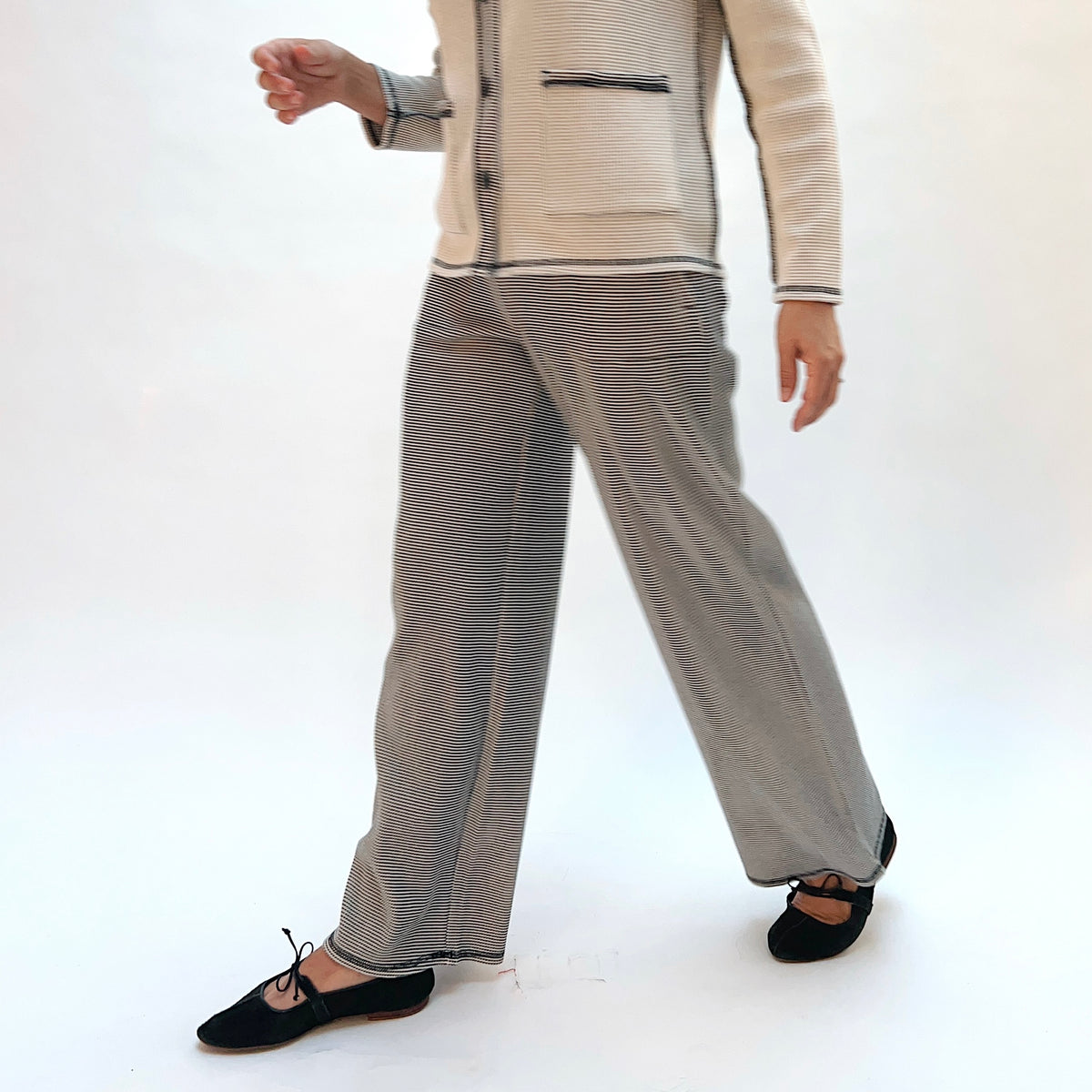 Habitat Opposites Attract Pant in Winter White, front walking view showing the relaxed wide-leg cut and elastic waistband in fine stripe thermal knit
