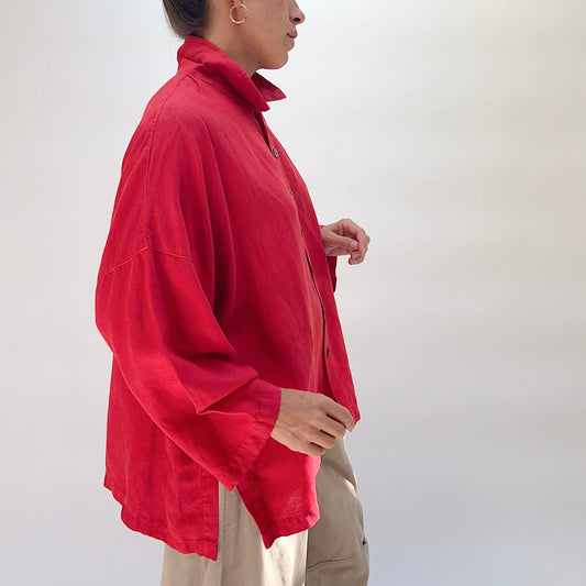 Eleven Stitch Linen Blend Big Shirt in Cayenne, side view on model, cayenne red lyocell-linen with stand collar, wood button front, wide sleeves, and curved side-slit hem, paired with khaki wide-leg trousers
