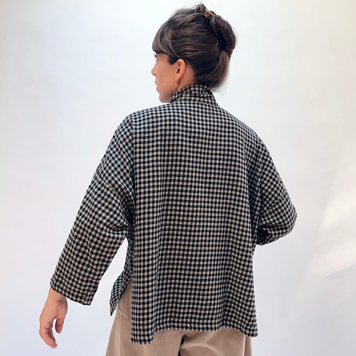 Eleven Stitch Small Check Big Shirt in Fennel, back view showing the relaxed boxy silhouette and side vents in black and natural small gingham check cotton
