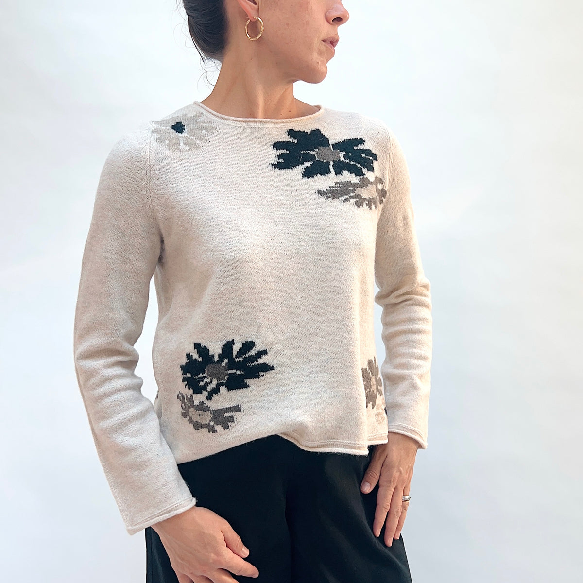 Habitat Cozy Bouquet Sweater in Dove Floral, front three-quarter view showing the boxy fit and intarsia floral motifs in navy and taupe
