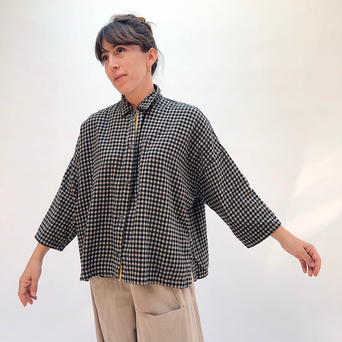 Eleven Stitch Small Check Big Shirt in Fennel, front view showing the boxy oversized silhouette in black and natural small gingham check with stand collar and mustard contrast placket
