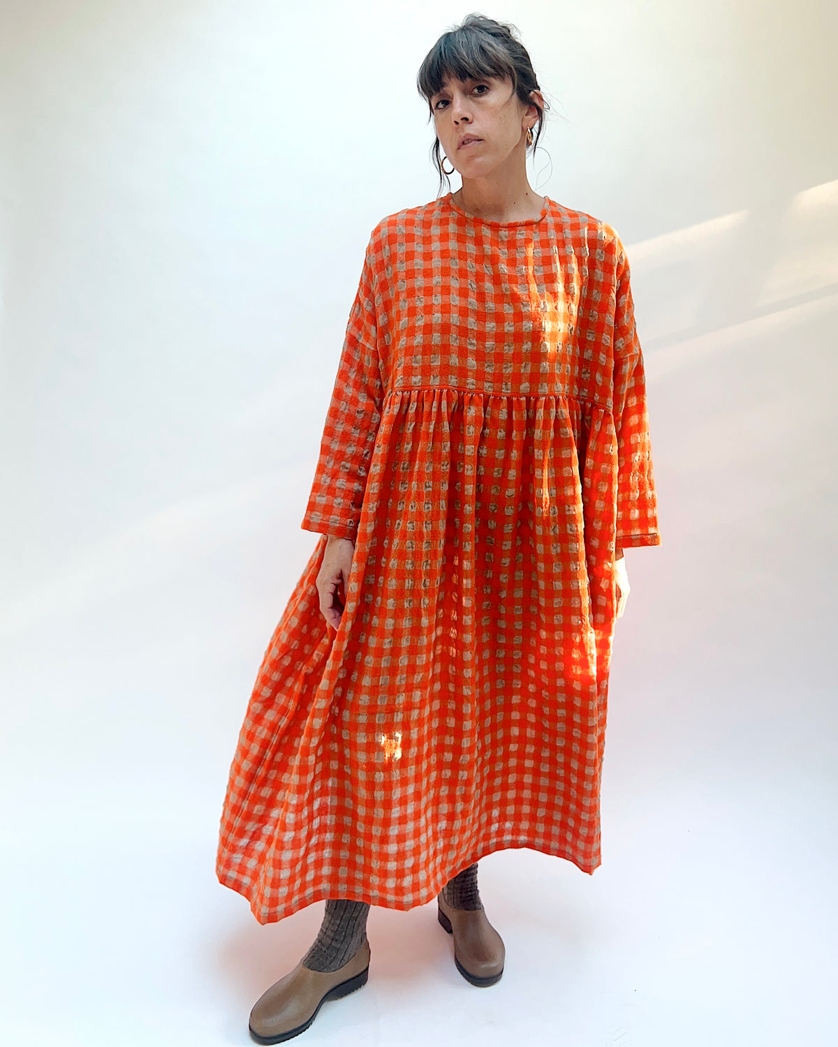 Ichi Antiquités Gingham Wool Check Dress in Beige & Orange, front view showing the round neckline, gathered waist seam, and full maxi skirt in orange and beige gingham
