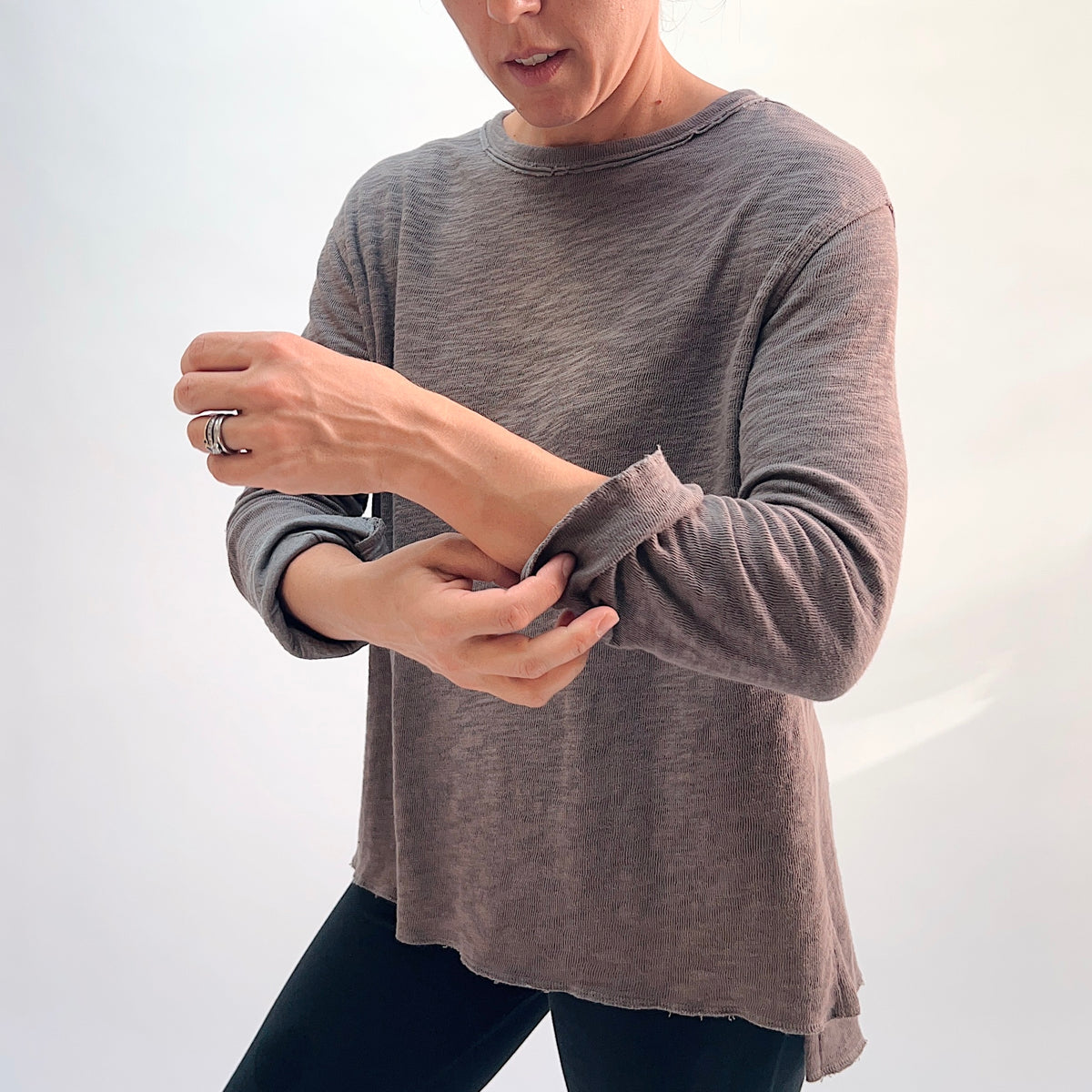North Star Base Double Cotton Beach Tee in Eiffel Tower, detail view showing the raw-edge cuff and double-layered fabric texture in warm taupe
